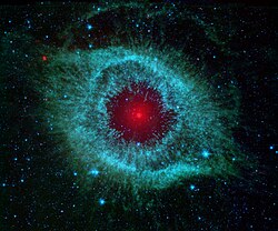 The Helix Nebula, blue shows infrared light of 3.6 to 4.5 micrometers, green shows infrared light of 5.8 to 8 micrometers, and red shows infrared light of 24 micrometers.