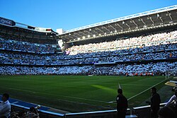 Real Madrid fans displaying the white of their club before El Clásico. Real Madrid fans also often wave Spanish flags at El Clásico games.[267]