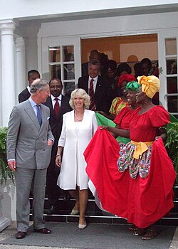 Women wearing the quadrille dress, greeting the British royal family (the King of Jamaica is the same person as the King of the United Kingdom) in Jamaica