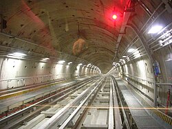 Inside a tunnel on the Turin Metro, the interlocking tunnel lining segments placed by a tunnel boring machine can be clearly seen.