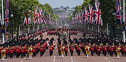 Vertical displays of the Union Flag during a parade for Elizabeth II's official birthday