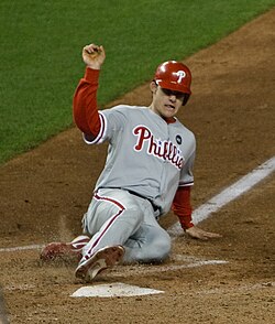 A runner sliding into home plate and scoring.