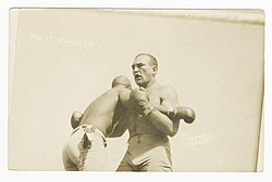 James J. Jeffries (right) using underhooks against Jack Johnson