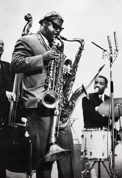 Rahsaan Roland Kirk playing simultaneously his "manzello" (left), "stritch" (center), and tenor saxophone; Helinski Jazz Festival, 1964