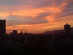 Particulates in the air causing shades of orange, yellow, pink, and grey in Mumbai during sunset