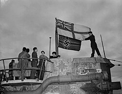 Seamen raise the White Ensign over the captured German U-boat U-190 in St. John's, Newfoundland 1945