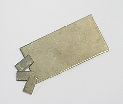 Three pieces of metallic foil with yellow taint