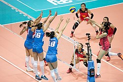 Three players performing a block, also known as a triple block