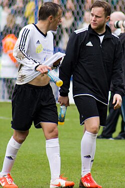 Neville and pop singer Olly Murs in a 2014 charity football match