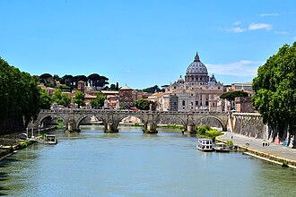 St. Peter's Basilica viewed from the Tiber; the Vatican Hill in the back and Castel Sant'Angelo in Rome to the right. Both the basilica and the hill are part of the sovereign state of Vatican City, the Holy See of the Catholic Church.