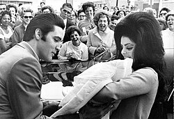 Presley and his wife, Priscilla Presley, holding their newborn daughter, Lisa Marie Presley, in 1968