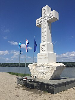 The Central Memorial Cross was erected in honour of all fallen defenders for Croatian freedom in October 1998 at the estuary of river Vuka. The work of Šime Vidulin. It is symbolically made of stone from Brač and Istria, with an inscription in glagolitic: "Navik on živi ki zgine pošteno" ("The one who dies honestly, lives forever "), verses sung by Fran Krsto Frankopan, and the words, "To all the victims for Free Croatia".