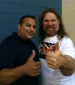 "Hacksaw" Duggan poses with a fan at an independent show in 2013.