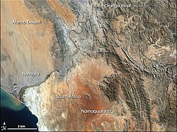This image shows the last 100 km (62 mi) or so of the Orange River, in which the gravel deposits in the river bed and along the banks are rich with diamonds, and several diamond mines operate along this stretch.