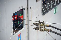 US sailors aboard USS Makin Island prepare to receive replenishment from USNS Yukon