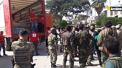 TFSA fighters and Turkish soldiers in Afrin city, while the Red Crescent distributes aid to the local civilians