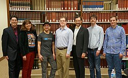 A group of Wikimedians of the Wikimedia DC chapter at the 2013 DC Wikimedia annual meeting standing in front of the Encyclopædia Britannica (back left) at the US National Archives