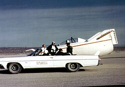 The M2-F1 and its 1963 Catalina convertible tow vehicle