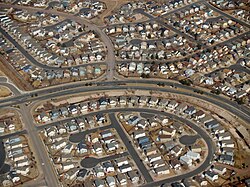 A suburban land use pattern in the United States (Colorado Springs, Colorado), showing a mix of residential streets and cul-de-sacs intersected by a four-lane road.