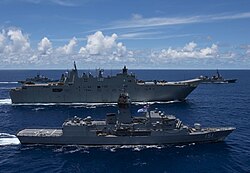 HMAS Canberra (L02), a Canberra-class landing helicopter dock, and HMAS Arunta, an Anzac-class frigate, sailing in formation
