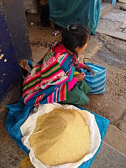 Quinoa seller at market in Calca, Peru