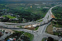 An intersection of Churchill–Roosevelt Highway and Uriah Butler Highway, 2009