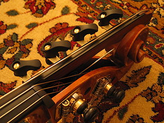 A low-C extension with wooden mechanical "fingers" that stop the string at C♯, D, E♭, or E. For orchestral passages which only go down to a low E, the "finger" at the nut is usually closed.