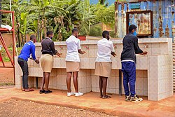 Students in Rwanda hand washing and wearing face masks during the COVID‑19 pandemic in the country