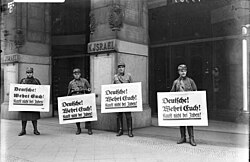Members of the SA picketing in front of a Jewish place of business with placards saying "Germans! Defend yourselves! Don't buy from Jews!" during the Nazi boycott of Jewish businesses, 1 April 1933
