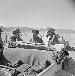 A conference between Lieutenant-General Bernard Montgomery, Lieutenant-General Freyberg and Lieutenant-General Herbert Lumsden, GOC X Corps, near Halfaya Pass before the army commander passed into Cyrenacia, 24 November 1942.