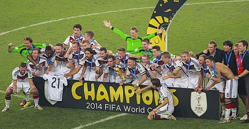 Germany posing with a "Champions" banner after the 2014 World Cup final
