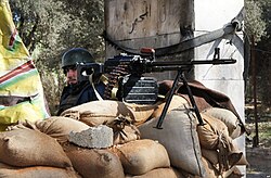A Syrian Army soldier manning a checkpoint outside of Damascus shortly after the outbreak of the Syrian civil war, 2012