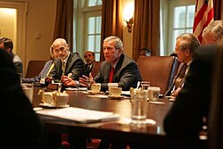 Flanked by Michael Chertoff, Secretary of Homeland Security, left, and Secretary of Defense Donald Rumsfeld, President Bush meets with members of the Task Force on Hurricane Katrina Recovery on August 31, 2005.