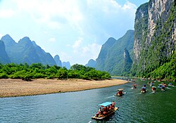 Tourist rafting boats cruise from Yangshuo County, on the Li River