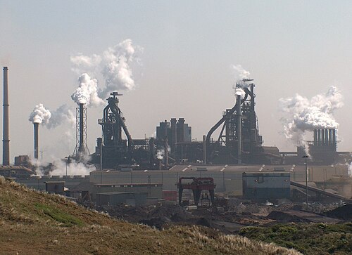 Integrated steel mill in the Netherlands. The two massive towers are blast furnaces.