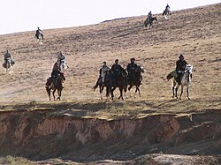 US Army Special Forces and US Air Force Combat Controllers with Northern Alliance troops on horseback in Samangan Province, 2001