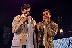 Merengue, sung by Juan Luis Guerra (left), and bachata, sung by Romeo Santos (right), are two very popular music genres native to the Dominican Republic.