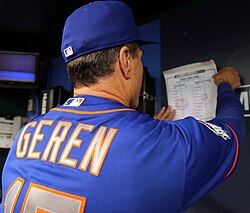 New York Mets bench coach Bob Geren posting the team's lineup card in the dugout during the 2015 World Series