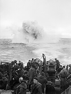 Depth charges detonate astern of the sloop HMS Starling. She participated in the sinking of 14 U-boats throughout the war