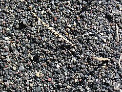 Close up of black volcanic sand from Perissa, Santorini, Greece