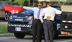 Oklahoma City Police Department detectives in "plainclothes" attire investigating a homicide crime scene