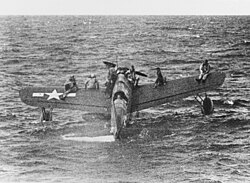 Downed American airmen near Truk await rescue from USS Tang on the wings of an OS2U Kingfisher, 1 May 1944