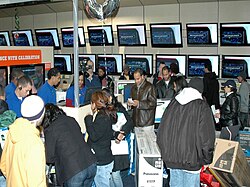 Shoppers at the flat-screen TV section of a Best Buy store