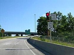A ramp meter limits the rate at which vehicles can enter the freeway
