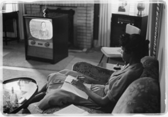 Student watching high school classes on TV during 1959 school year when schools were physically shut down