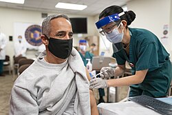 A US airman receiving a COVID‑19 vaccine, December 2020