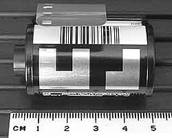 135 Film Cartridge with DX barcode (top) and DX CAS code on the black and white grid below the barcode. The CAS code shows the ISO, number of exposures, exposure latitude (+3/−1 for print film).
