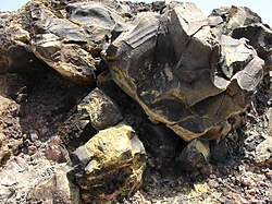 Deposit of sulfur on a rock, caused by volcanic gas
