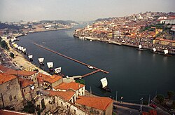 A panned out image of city buildings either side of a river