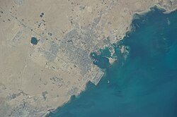 A satellite view of Doha on the East coast of Qatar. As with most world cities, Doha developed on the waterfront. Established in today's Souq Waqif area, it spread out gradually in a radial pattern with ring roads.